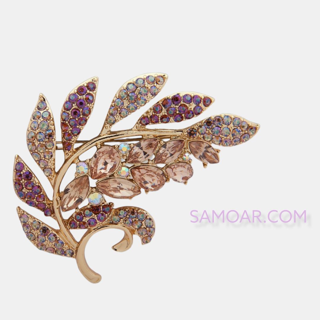 دبوس ذهبي اللون على شكل حجر وأوراق كريستال